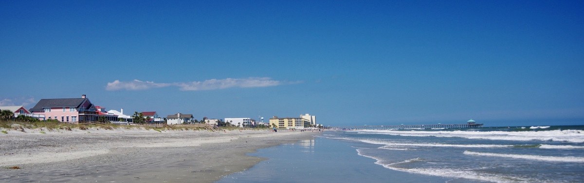 Folly Beach shoreline with beach houses and the pier beyond