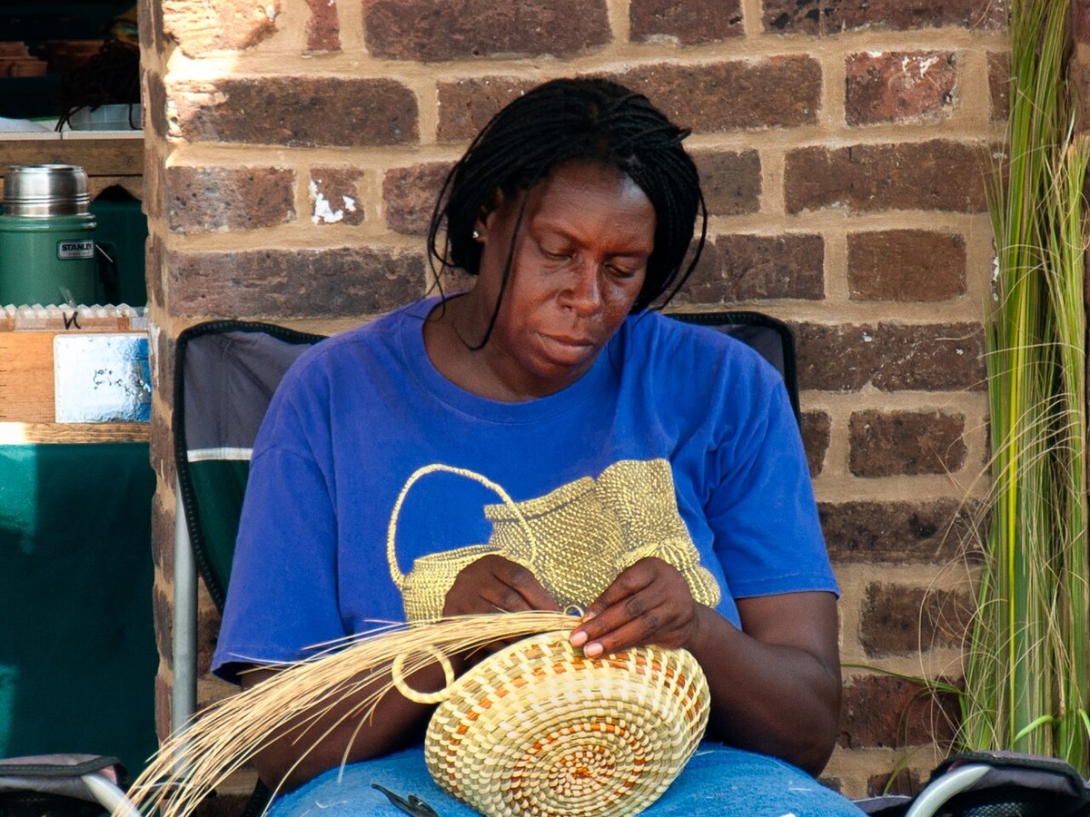 Sweetgrass basket maker weaving a traditional Lowcountry basket
