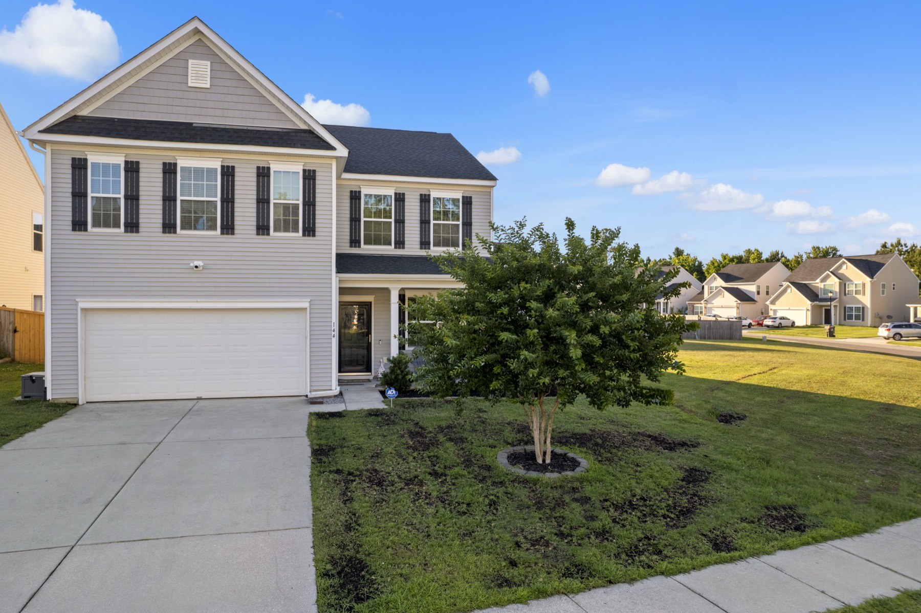 Aerial view of 144 Weeping Cypress Drive, a two-story home on a corner lot in Cypress Grove, Moncks Corner SC