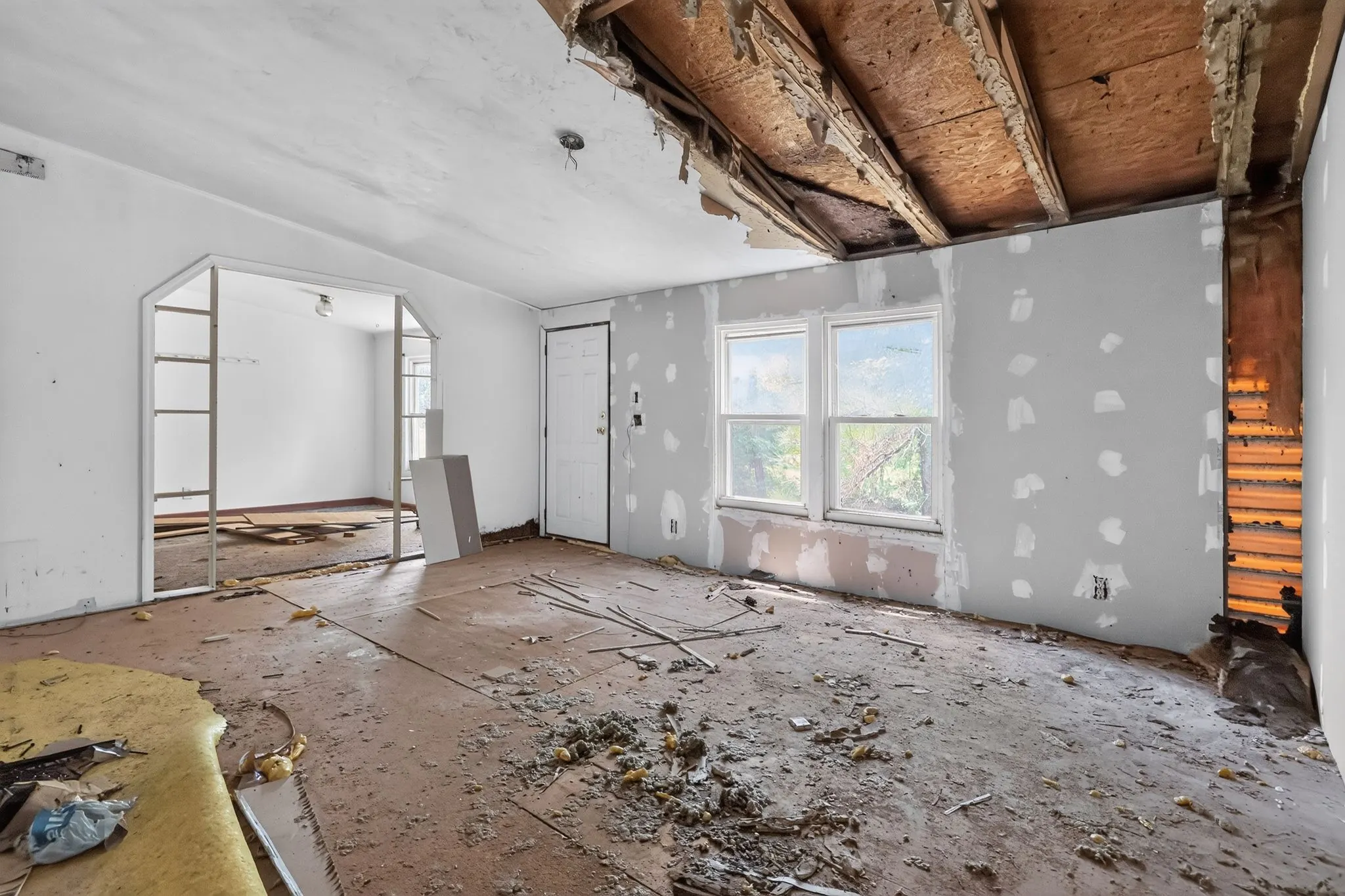 Gutted living area with ceiling removed at 1929 Revis Pl