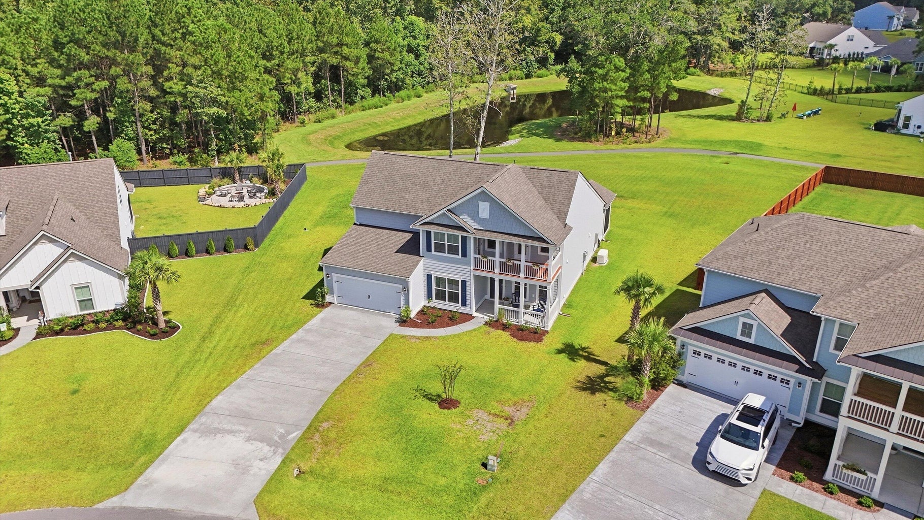 Aerial view of the house, long driveway, and pond at 5085 Lady Bird Alley