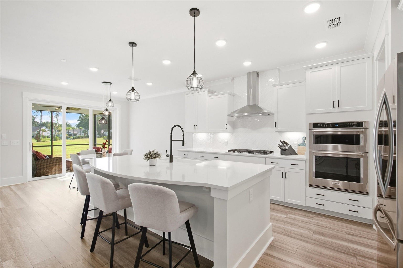 Kitchen island, gas range, and white cabinets