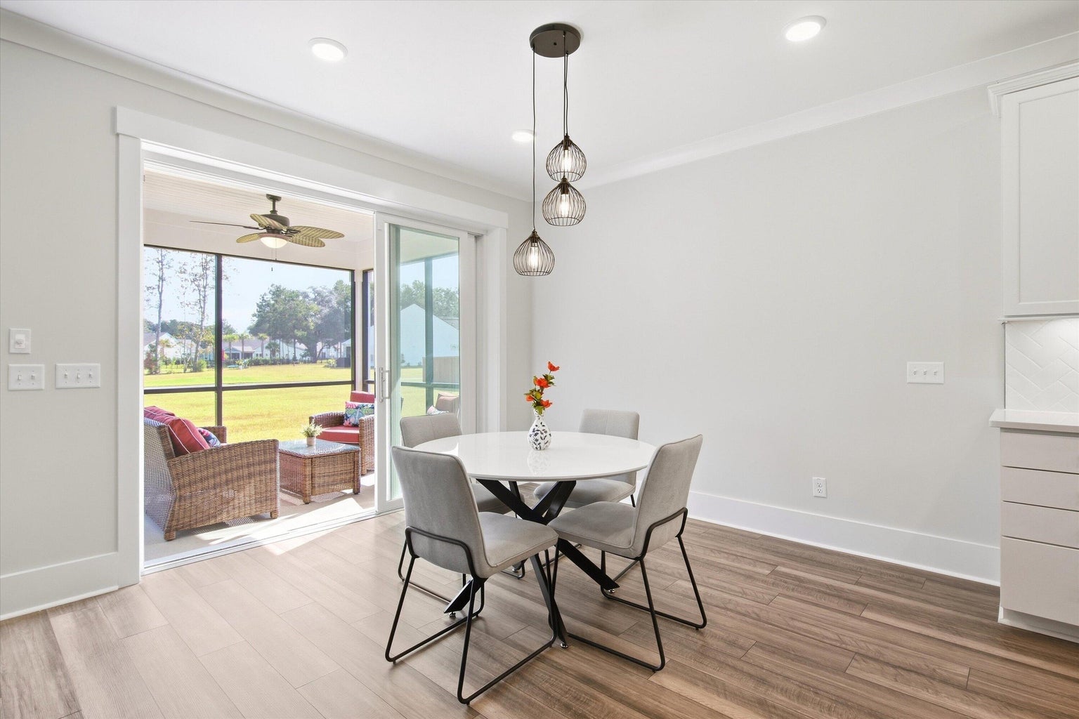 Telescoping glass doors open from the dining area to the screened porch